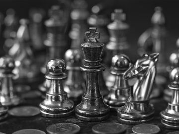 chess pieces and coins