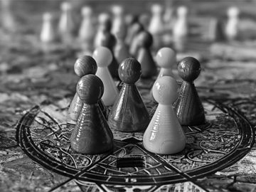 Game pieces standing on a large patterned board